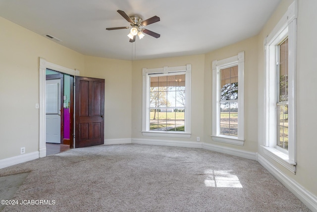 unfurnished room featuring ceiling fan and carpet