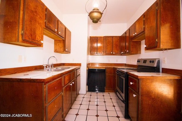 kitchen featuring tile countertops, sink, stainless steel electric range, and black dishwasher