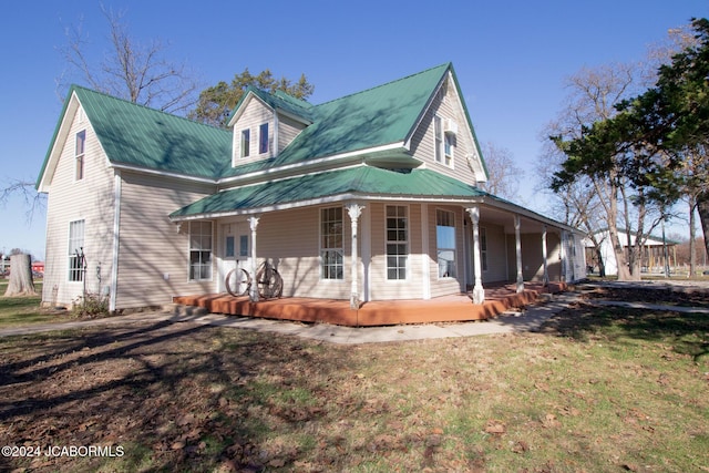 view of front of property with a porch and a front lawn