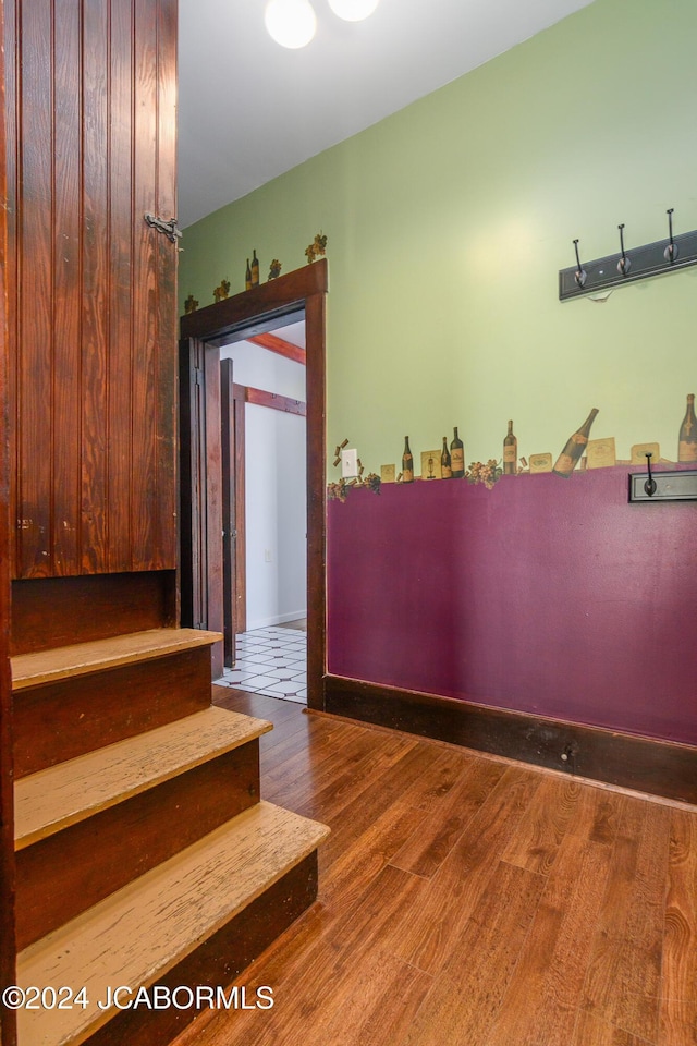 staircase with hardwood / wood-style floors