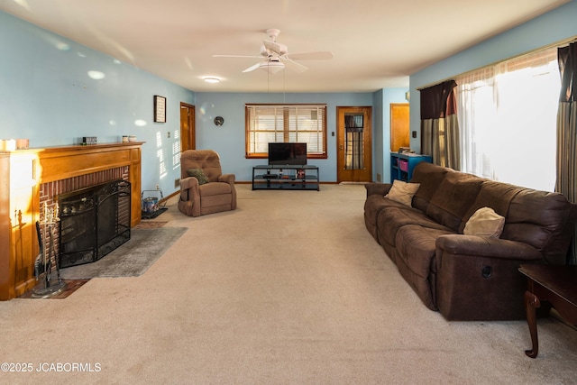 carpeted living room featuring ceiling fan, plenty of natural light, and a fireplace