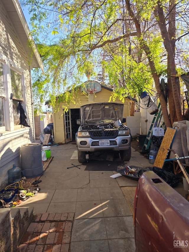 view of vehicle parking with fence