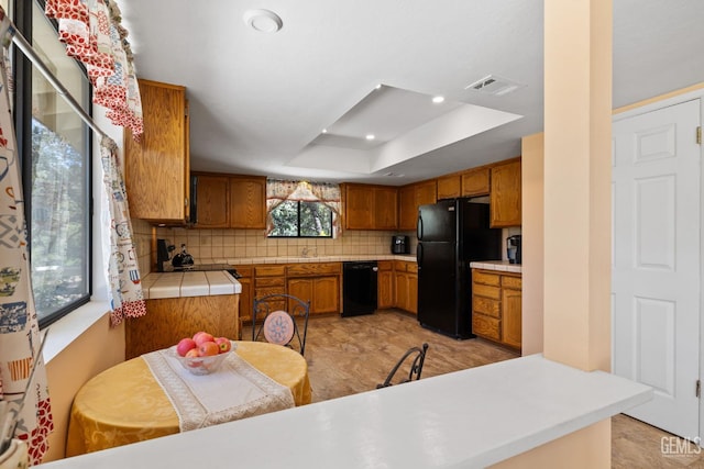 3113 Raccoon Dr, Lake Isabella, CA 93240 - kitchen featuring black appliances, brown cabinetry, tasteful backsplash, a raised ceiling, and a sink