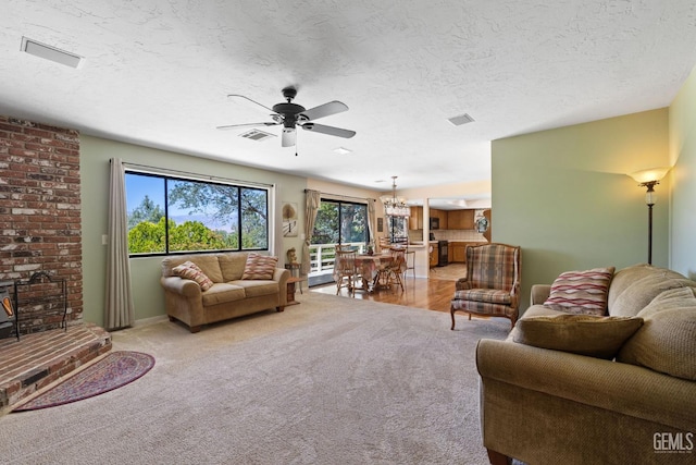 3113 Raccoon Dr, Lake Isabella, CA 93240 - living room with a ceiling fan, healthy amount of natural light, light carpet, a chandelier, and a textured ceiling