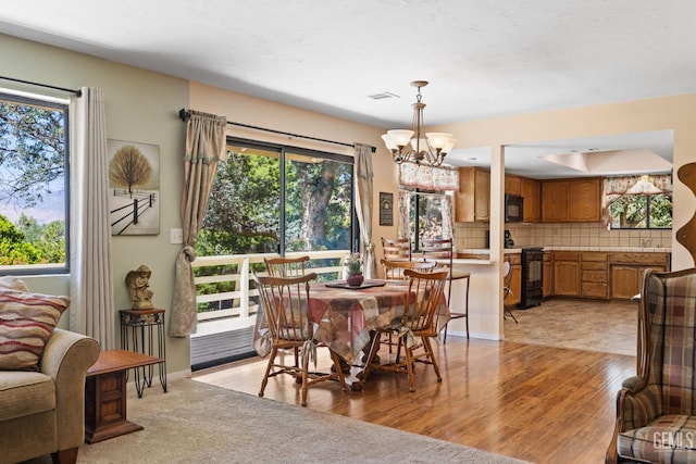 3113 Raccoon Dr, Lake Isabella, CA 93240 - dining space with a chandelier, light wood-style floors, and baseboards