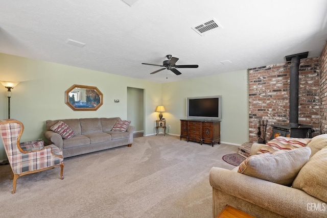 3113 Raccoon Dr, Lake Isabella, CA 93240 - carpeted living room featuring a wood stove, ceiling fan, and baseboards