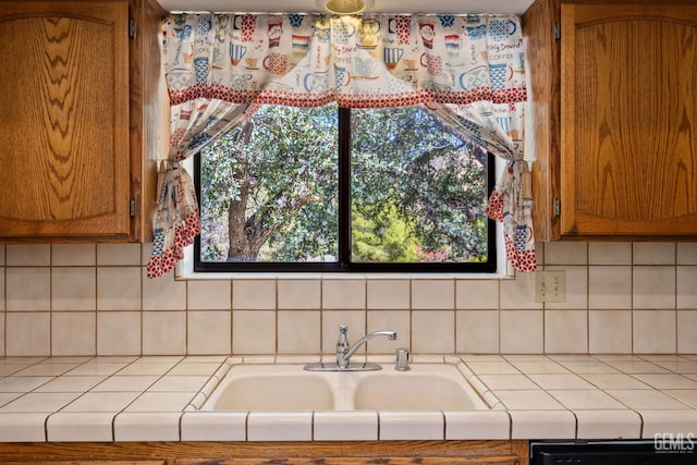 3113 Raccoon Dr, Lake Isabella, CA 93240 - kitchen featuring tile counters, a sink, dishwasher, brown cabinetry, and tasteful backsplash