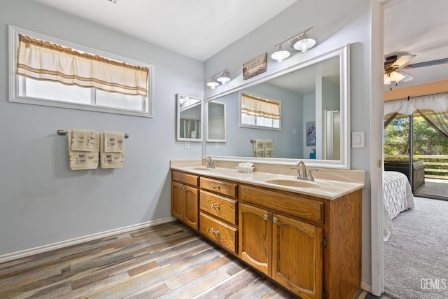 3113 Raccoon Dr, Lake Isabella, CA 93240 - ensuite bathroom featuring double vanity, ceiling fan, wood finished floors, and baseboards