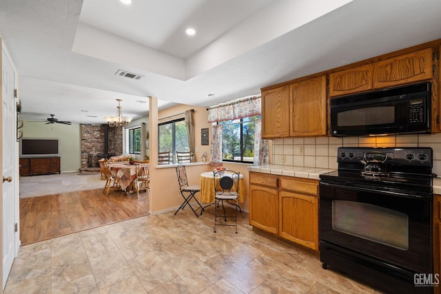 3113 Raccoon Dr, Lake Isabella, CA 93240 - kitchen featuring black appliances, a raised ceiling, tile countertops, a chandelier, and recessed lighting