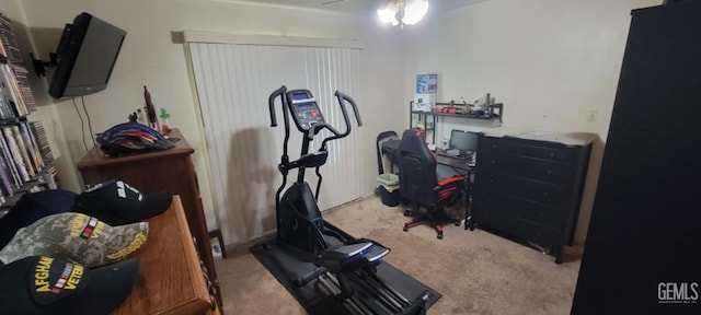 exercise room with ceiling fan and light carpet