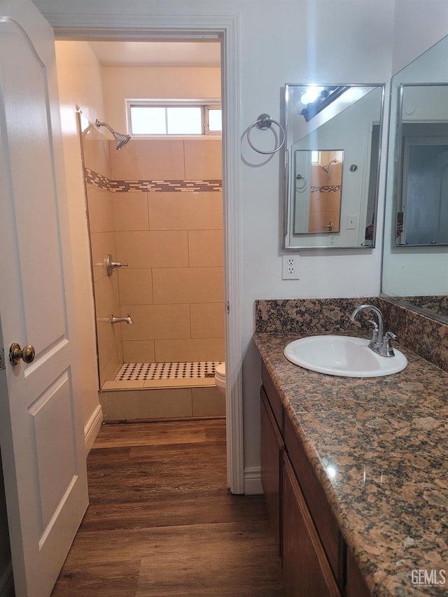 7205 Colony Park Dr, Bakersfield, CA 93313 - bathroom featuring a shower stall, vanity, and wood finished floors