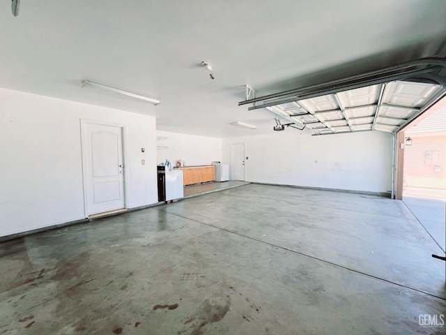 7205 Colony Park Dr, Bakersfield, CA 93313 - garage with a garage door opener and washer / dryer
