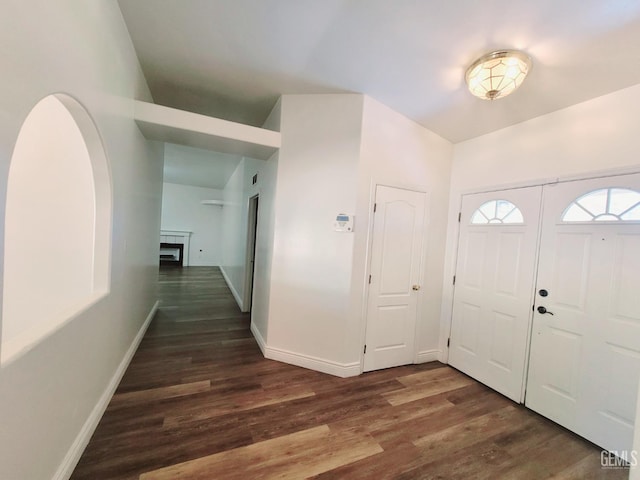 7205 Colony Park Dr, Bakersfield, CA 93313 - foyer featuring dark wood finished floors, a fireplace, and arched walkways