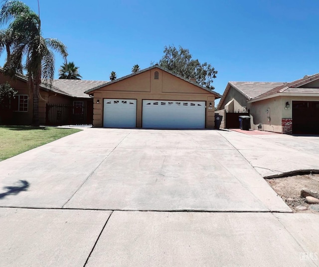 7205 Colony Park Dr, Bakersfield, CA 93313 - ranch-style home featuring driveway, a garage, and stucco siding
