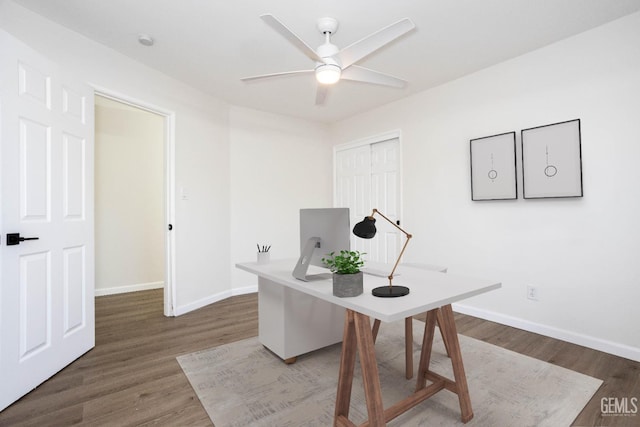 home office featuring wood-type flooring and ceiling fan