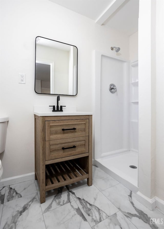 bathroom with a shower, vanity, and toilet