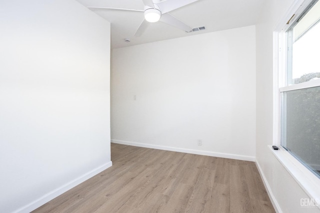 spare room featuring light hardwood / wood-style flooring and ceiling fan