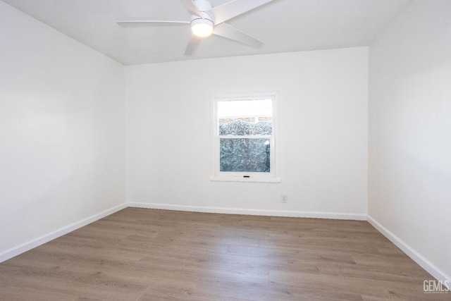 unfurnished room with ceiling fan and wood-type flooring