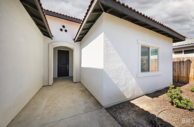 8412 Jean Anne St, Bakersfield, CA 93314 - view of exterior entry featuring stucco siding and a tile roof