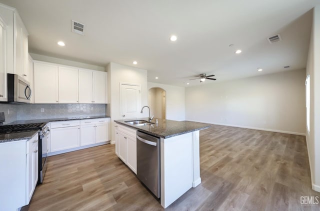 8412 Jean Anne St, Bakersfield, CA 93314 - kitchen featuring stainless steel appliances, arched walkways, a ceiling fan, decorative backsplash, and recessed lighting