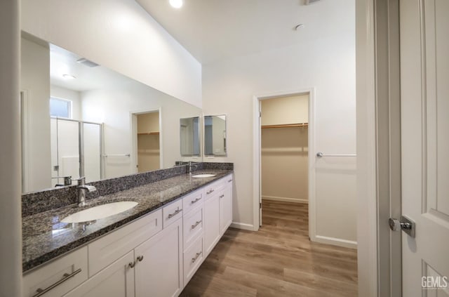 8412 Jean Anne St, Bakersfield, CA 93314 - full bathroom with a spacious closet, double vanity, wood finished floors, and a shower stall