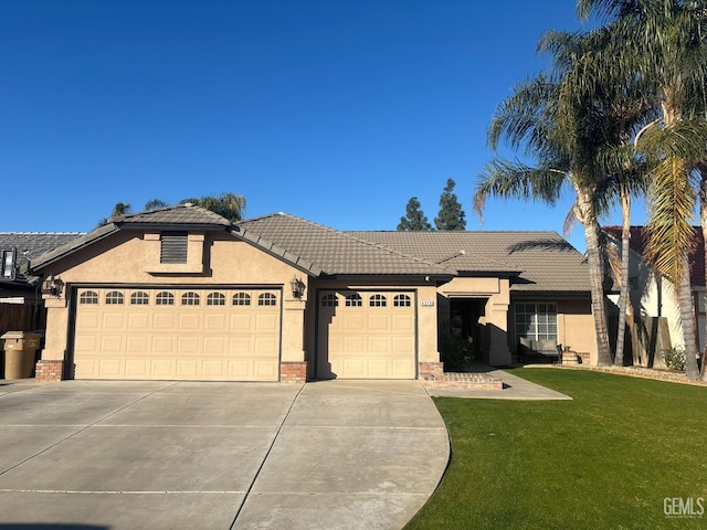 single story home featuring a garage and a front lawn