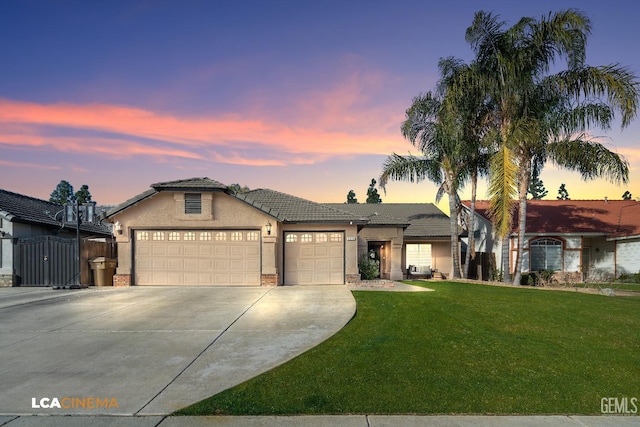 view of front of house with a garage and a lawn