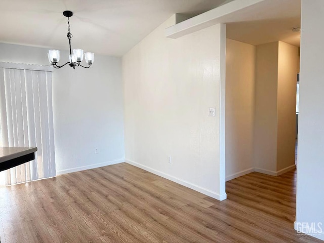 5717 Arc Dome Ave, Bakersfield, CA 93313 - unfurnished dining area featuring wood finished floors and a chandelier