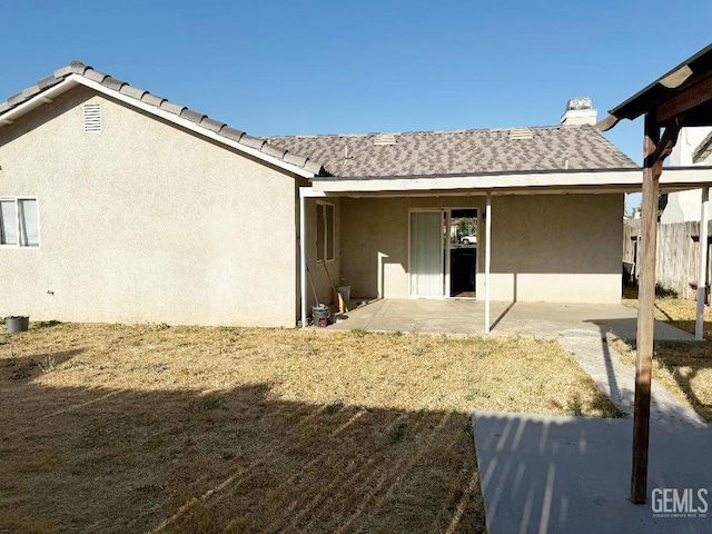 5717 Arc Dome Ave, Bakersfield, CA 93313 - rear view of house featuring stucco siding and a patio area