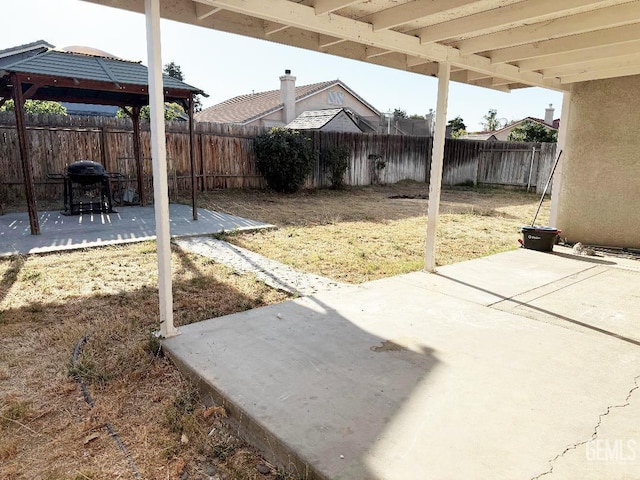 5717 Arc Dome Ave, Bakersfield, CA 93313 - fenced backyard with a gazebo, a patio area, and a grill