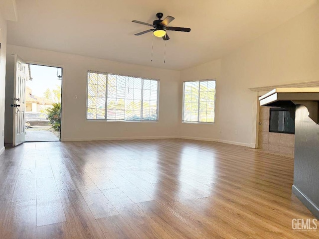 5717 Arc Dome Ave, Bakersfield, CA 93313 - unfurnished living room with wood finished floors, vaulted ceiling, and ceiling fan