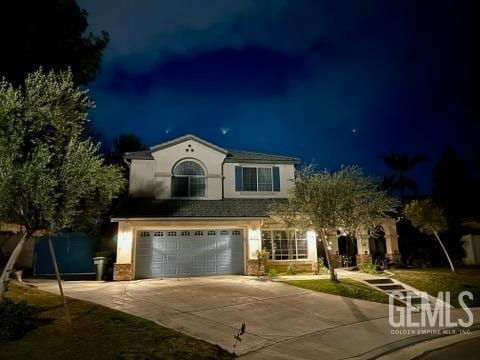 view of front of property with a garage and concrete driveway