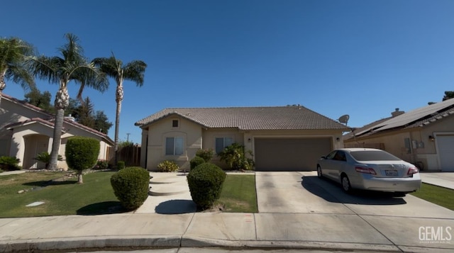 6605 High Peaks Dr, Bakersfield, CA 93313 - view of front of house featuring a tiled roof, an attached garage, concrete driveway, stucco siding, and a front lawn