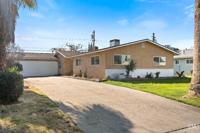 ranch-style home with a garage and a front lawn