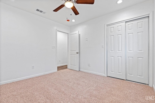 unfurnished bedroom with a closet, ceiling fan, and carpet