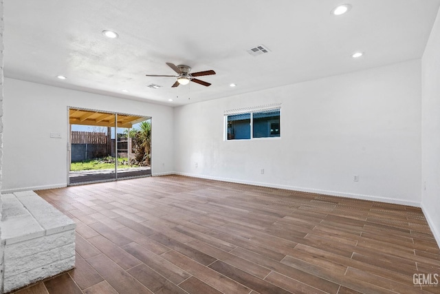 unfurnished living room featuring dark hardwood / wood-style floors and ceiling fan