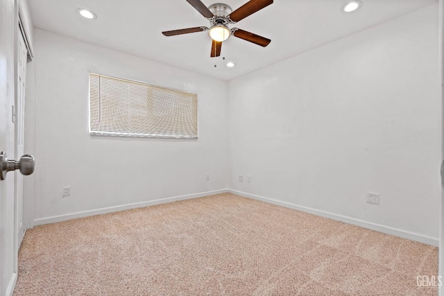 carpeted spare room with ceiling fan