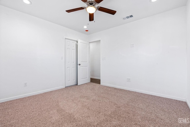 unfurnished bedroom featuring ceiling fan and carpet floors