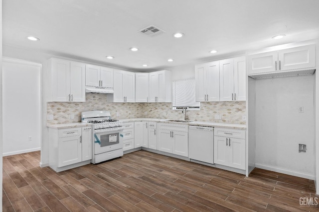 kitchen with white cabinetry, sink, white appliances, and dark hardwood / wood-style flooring