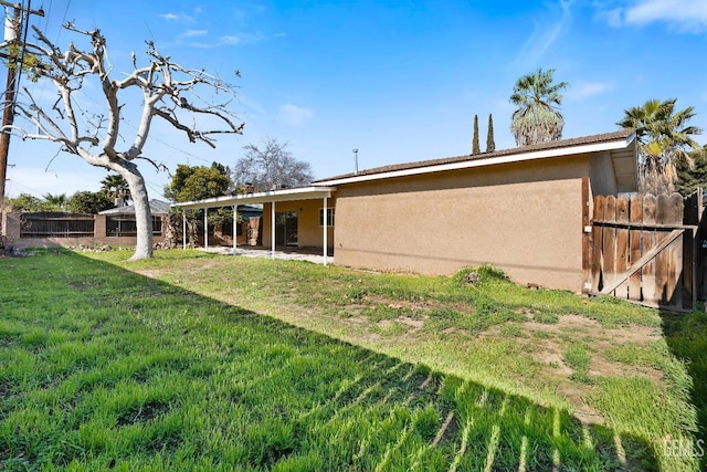 back of property featuring a lawn