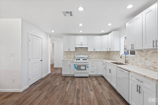 kitchen with dark hardwood / wood-style floors, white cabinetry, sink, and white appliances