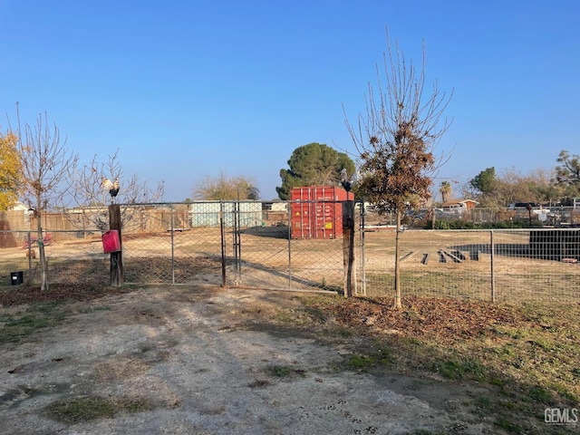 view of yard featuring fence and a gate