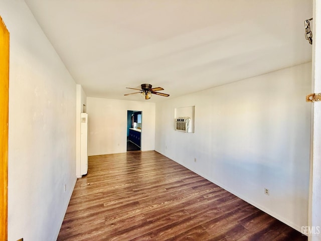 unfurnished room featuring ceiling fan, a wall mounted AC, and wood finished floors