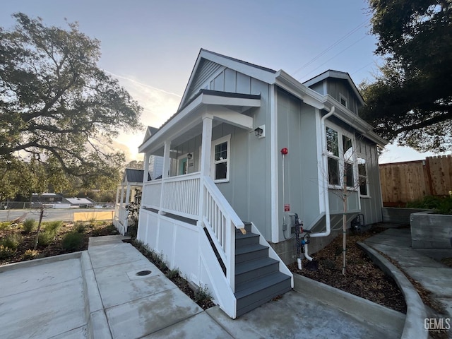 5929 Gran Paseo Way, Atascadero, CA 93422 - view of front of home featuring fence, a porch, and board and batten siding