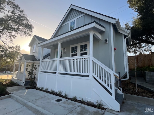 5929 Gran Paseo Way, Atascadero, CA 93422 - view of front of home featuring a porch, fence, and board and batten siding