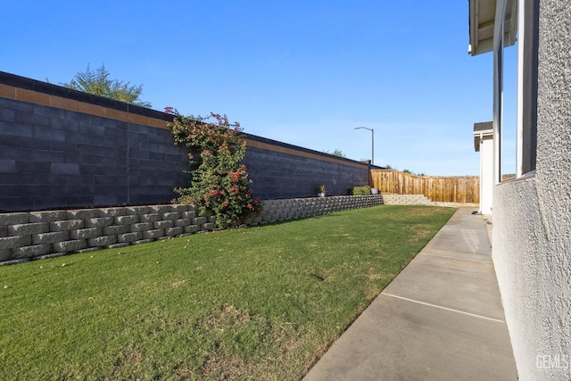 view of yard with a fenced backyard