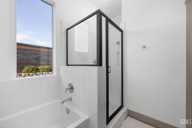 bathroom with a garden tub and a stall shower