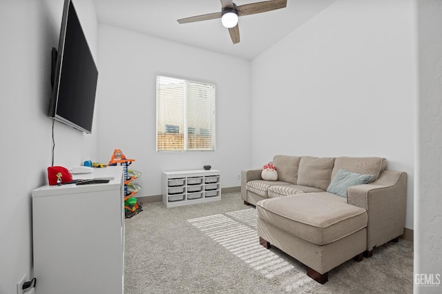 living room with light carpet, ceiling fan, and baseboards