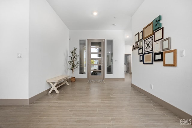 interior space with wood finish floors, recessed lighting, and baseboards