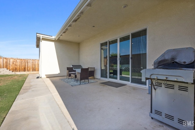 view of patio / terrace with outdoor dining space, fence, and grilling area